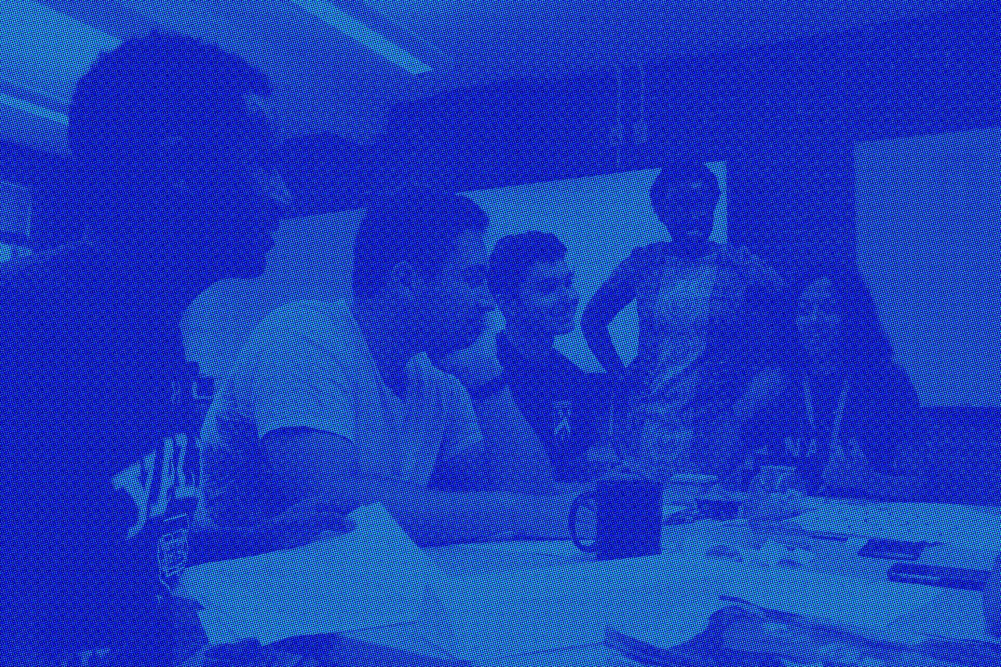 Small group of students sits at table with brainstorming supplies